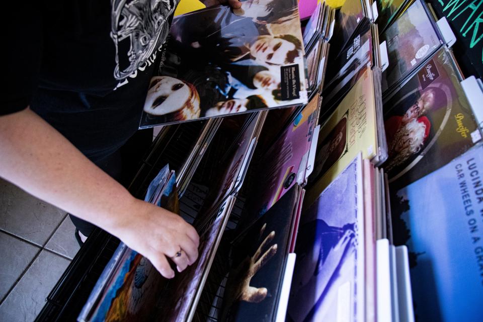 Liz Cochran, the owner of Stellar Records in Fort Myers stocks merchandise on Thursday, April 11, 2024. The store sells new and vintage vinyl records, cassette tapes, vintage decor and more. The store will take part in Record Store Day, where U.S. record stores sell cool, limited-edition vinyl records. The event is on April 20.