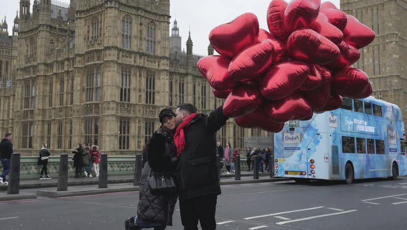 A couple poses for a photograph during Valentine’s Day festivities in London on Wednesday, Feb. 14, 2024.