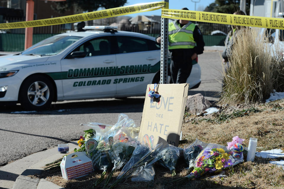 Flowers and a sign reading "love over hate" lay near a gay nightclub in Colorado Springs, Colo., Sunday, Nov. 20, 2022 where a shooting occurred late Saturday night. (AP Photo/Geneva Heffernan)