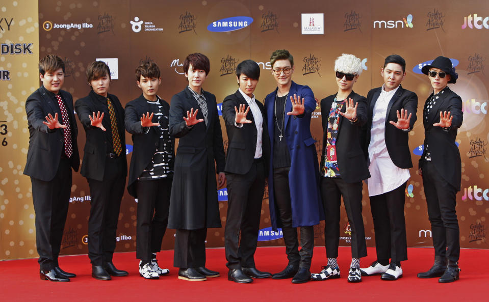 South Korean boy group Super Junior poses for photographers as they arrive on the red carpet ahead of the 27th Golden Disk Awards in Sepang, Malaysia, Tuesday, Jan. 15, 2013. (AP Photo/Lai Seng Sin)