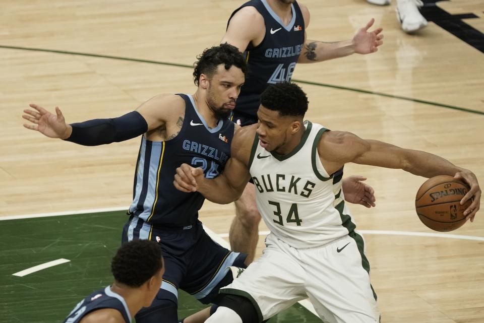 Milwaukee Bucks' Giannis Antetokounmpo tries to get by Memphis Grizzlies' Dillon Brooks during the first half of an NBA basketball game Saturday, April 17, 2021, in Milwaukee. (AP Photo/Morry Gash)