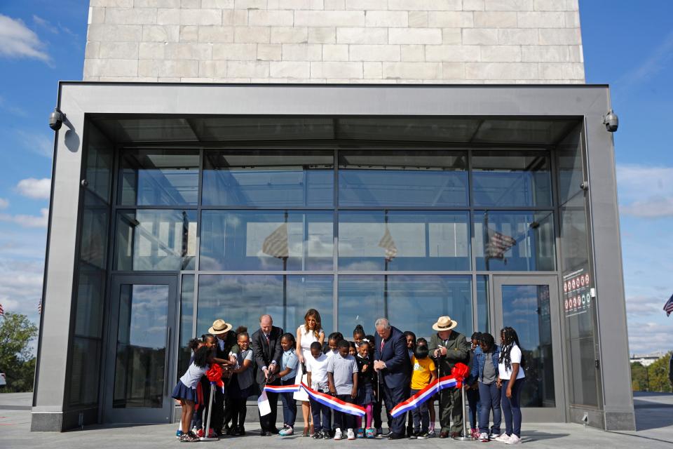 First lady Melania Trump helps cut the ribbon to re-open the Washington Monument, joined by students from Amidon-Bowen Elementary School in Washington, on Sept. 19, 2019.