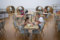 Visitors enjoy a buffet dinner at the Ocean Star complex along the coastline of Yantai in eastern China's Shandong province on Tuesday, Aug. 22, 2023. (AP Photo/Ng Han Guan)