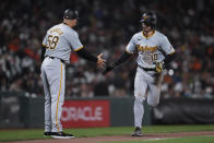 Pittsburgh Pirates' Bryan Reynolds, right, celebrates with third base coach and field coordinator Mike Rabelo, left, after hitting a two-run home run against the San Francisco Giants during the 10th inning of a baseball game Saturday, April 27, 2024, in San Francisco. (AP Photo/Godofredo A. Vásquez)