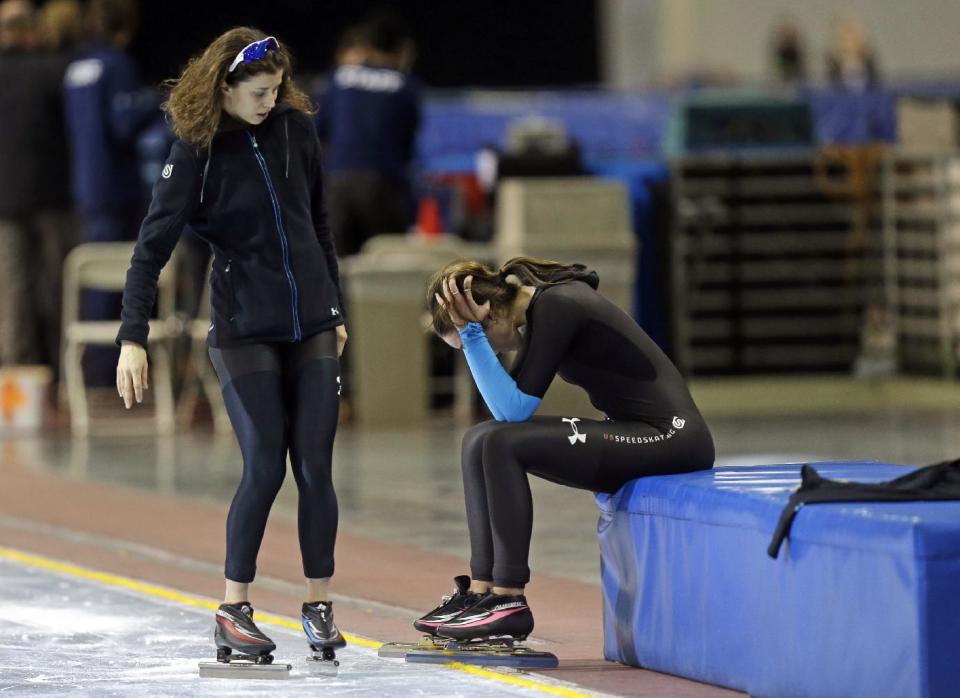 First-place finisher Maria Lamb, left, skates up to second-place finisher Petra Acker after competing in the women's 5,000 meters during the U.S. Olympic speedskating trials Wednesday, Jan. 1, 2014, in Kearns, Utah. (AP Photo/Rick Bowmer)