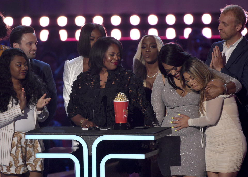 FILE - Participants and crew from "Surviving R. Kelly" accept the award for best documentary at the MTV Movie and TV Awards on June 15, 2019, in Santa Monica, Calif. On Jan. 3, 2019, Lifetime aired the documentary "Surviving R. Kelly," which revisited old allegations against him and brought new ones into the spotlight. Kelly, the 54-year-old R&B singer, will once again head to court this week. His federal trial in New York begins Wednesday, Aug. 18. 2021, and will explore years of sexual abuse allegations. He has vehemently denied the allegations against him.(Photo by Chris Pizzello/Invision/AP, File)