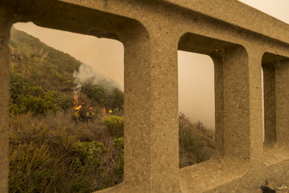 Firefighters with Vandenberg Air Force Base, light a back burn to help control the Dolan Fire at Limekiln State Park in Big Sur, Calif,. Friday, Sept. 11, 2020. (AP Photo/Nic Coury)