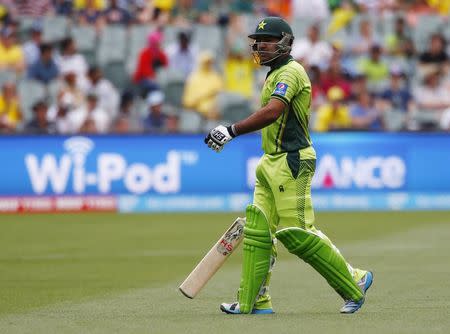 Pakistan's batsman Sarfraz Ahmed walks off the field after being caught out by Australia's Shane Watson during their Cricket World Cup quarter final match in Adelaide, March 20, 2015. REUTERS/David Gray