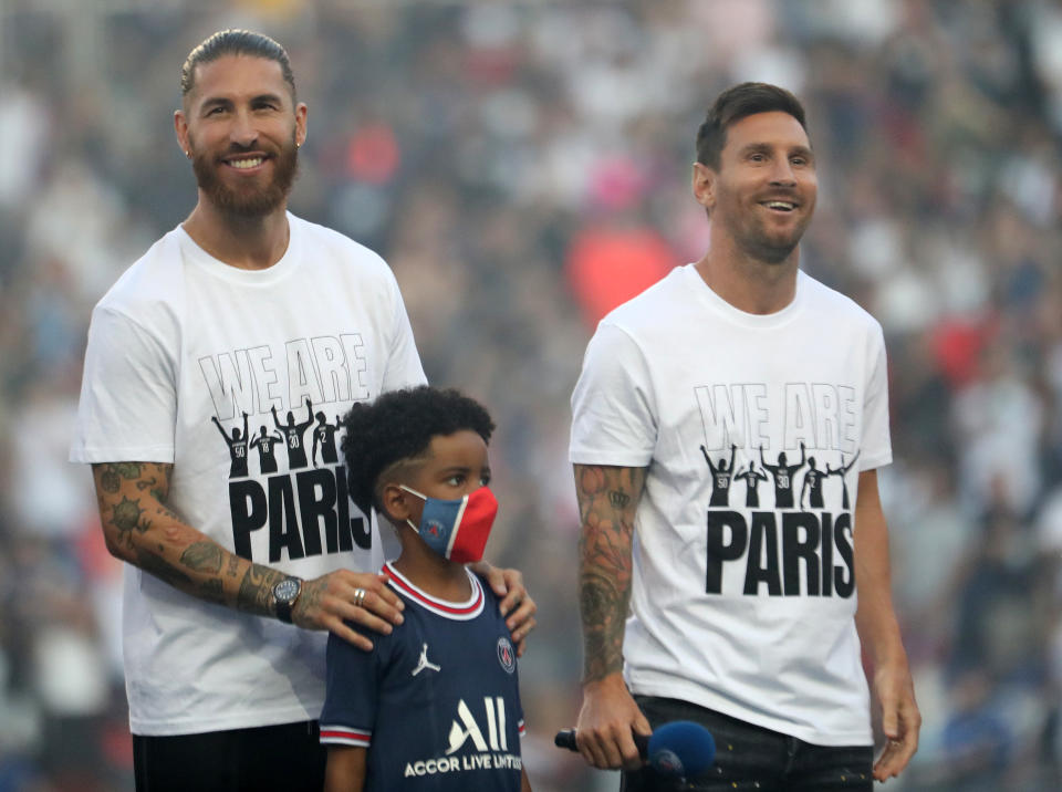 Soccer Football - Ligue 1 - Paris St Germain v RC Strasbourg - Parc des Princes, Paris, France - August 14, 2021  Paris St Germain's Sergio Ramos and Lionel Messi are presented to the fans inside the stadium before the match REUTERS/Sarah Meyssonnier