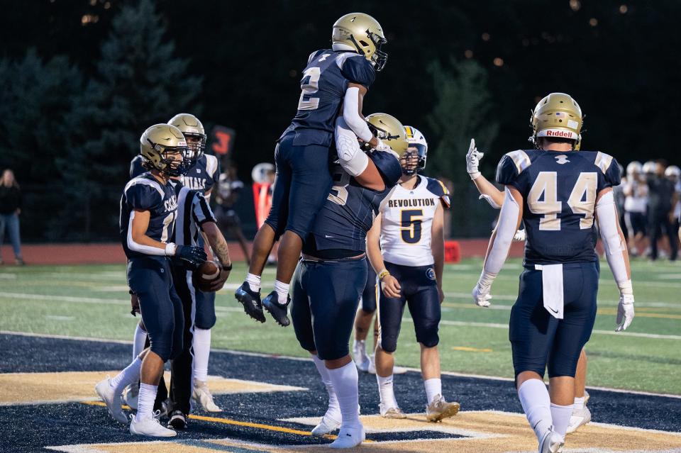 Shrewsbury's Jarrett Ellis lifts Josiah Spiegel in celebration after Spiegel scored their third touchdown of the game versus Acton-Boxborough on Thursday September 14, 2023 in Shrewsbury.