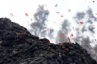 <p>Lava erupts from a fissure east of the Leilani Estates subdivision during ongoing eruptions of the Kilauea Volcano in Hawaii, on May 12, 2018. (Photo: Terray Sylvester/Reuters) </p>