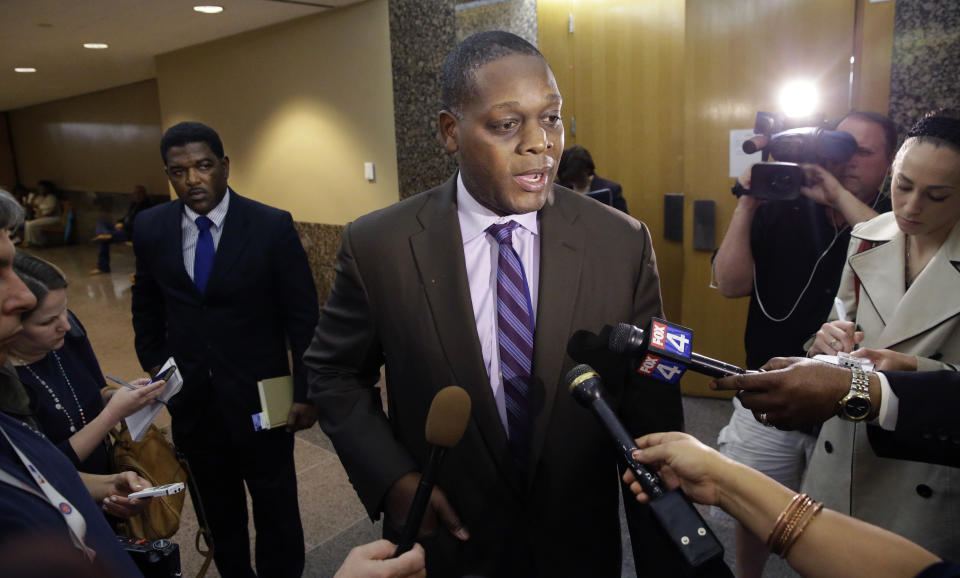 Dallas District attorney Craig Watkins speaks to reporters after a court hearing setting the probation conditions for Sir Young in Dallas Thursday, May 8, 2014. A district court judge has reversed a previous order and imposed a series of probationary requirements for the 20-year-old man convicted of raping a schoolmate. The initial punishment for Young sparked a backlash when a prior judge in Dallas sentenced him to five years of probation and declined to impose standard conditions of probation for sex offenders. (AP Photo/LM Otero)