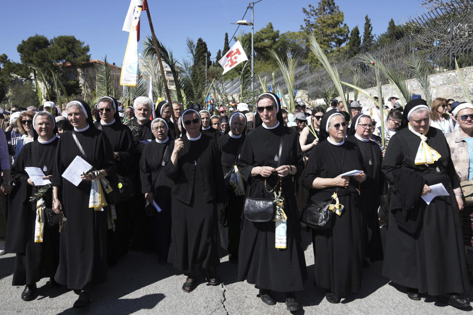 Nuns and Christian worshippers walk in the Palm Sunday procession on the Mount of Olives in east Jerusalem, Sunday, April 2, 2023. The procession observes Jesus' entrance into Jerusalem in the time leading up to his crucifixion, which Christians mark on Good Friday. (AP Photo/Mahmoud Illean)