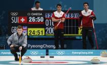 Curling - Pyeongchang 2018 Winter Olympics - Men’s Tie-Breaker - Switzerland v Britain - Gangneung Curling Center - Gangneung, South Korea - February 22, 2018 - Thomas Muirhead of Britain indicates a play as Benoit Schwarz, Claudio Patz and Peter de Cruz of Switzerland watch. REUTERS/Cathal McNaughton