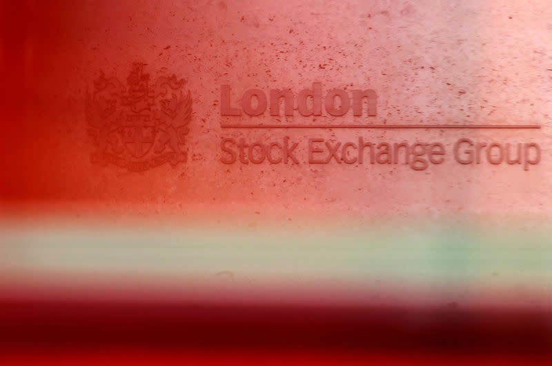 FILE PHOTO: A red London bus passes the Stock Exchange in London, Britain, February 9, 2011. REUTERS/Luke MacGregor/File Photo