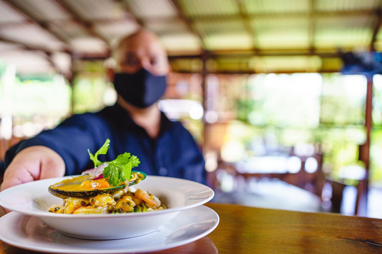 A restaurant server picks up an order