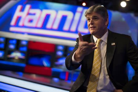 FILE PHOTO: Fox News Channel anchor Sean Hannity poses for photographs as he sits on the set of his show "Hannity" at the Fox News Channel's studios in New York City, October 28, 2014. REUTERS/Mike Segar