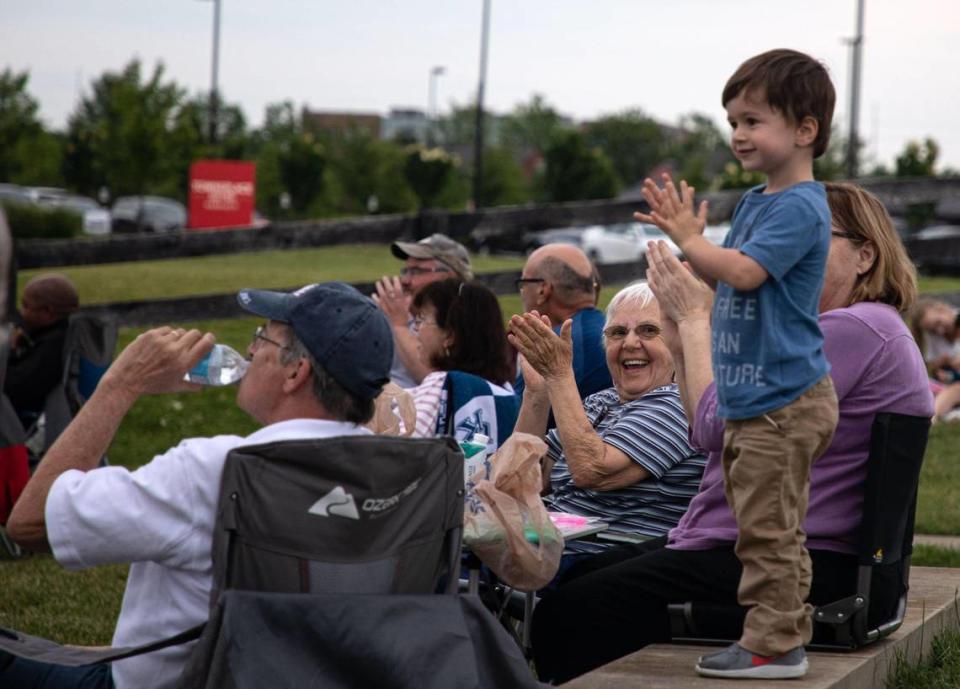 Rosmarie Smith cheers and smiles with her family at the end of a number put on by DoJo Jazz group during the weekly Big Band and Jazz performance at the MoonDance Amphitheater in Lexington, Ky., on June 1, 2021.