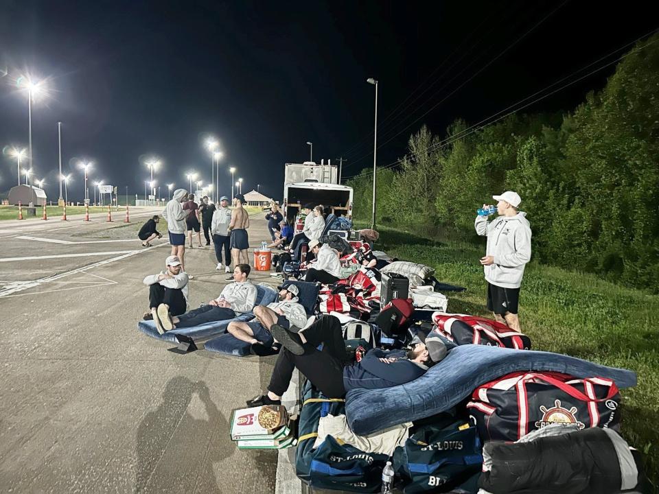 Peoria Rivermen players, coaching and team staff lounge on mattresses from their broken down team bus at an isolated Tennessee weigh station on around midnight Saturday morning on April 15, 2023.