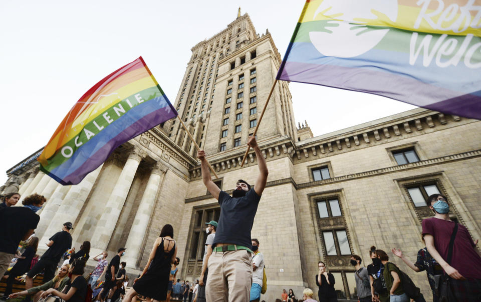 LGBT rights supporters protest in Warsaw, Poland, Saturday, Aug. 8, 2020. A large crowd of LGBT rights supporters gathered in Warsaw on Saturday to protest the arrest of a transgender activist who had carried out acts of civil disobedience against rising homophobia in Poland. (AP Photo/Czarek Sokolowski)