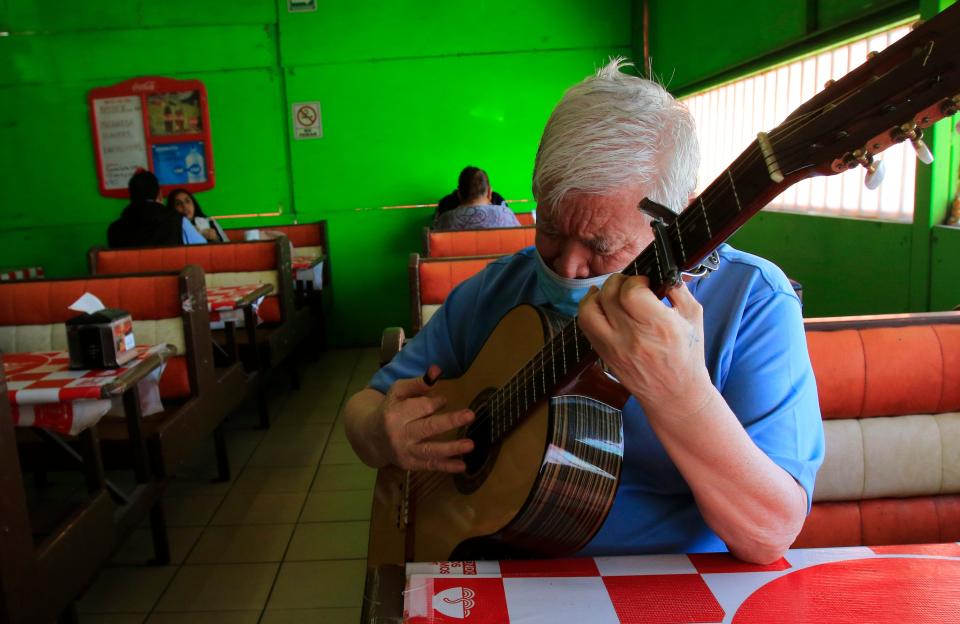 Mario Alberto Ramos plays the guitar for patrons at Los Metiches on Wednesday in Juárez.