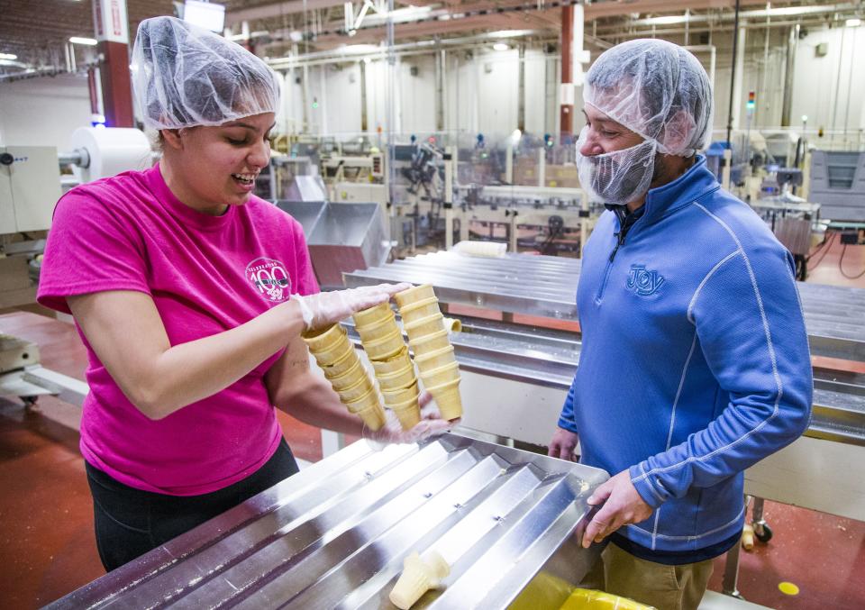 Packer Bralynn Watts moves cones while talking with general manager Joe Pozar, Jr.,  at the Joy Cone Company plant in Flagstaff, Wednesday, November 29, 2018.