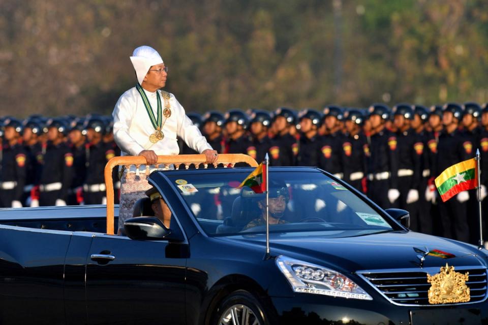 Myanmar's military chief Min Aung Hlaing stands in a car as he oversees a military display (AFP via Getty Images)