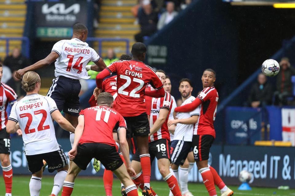 Victor Adeboyejo heads home against Lincoln City last season <i>(Image: Harry McGuire)</i>