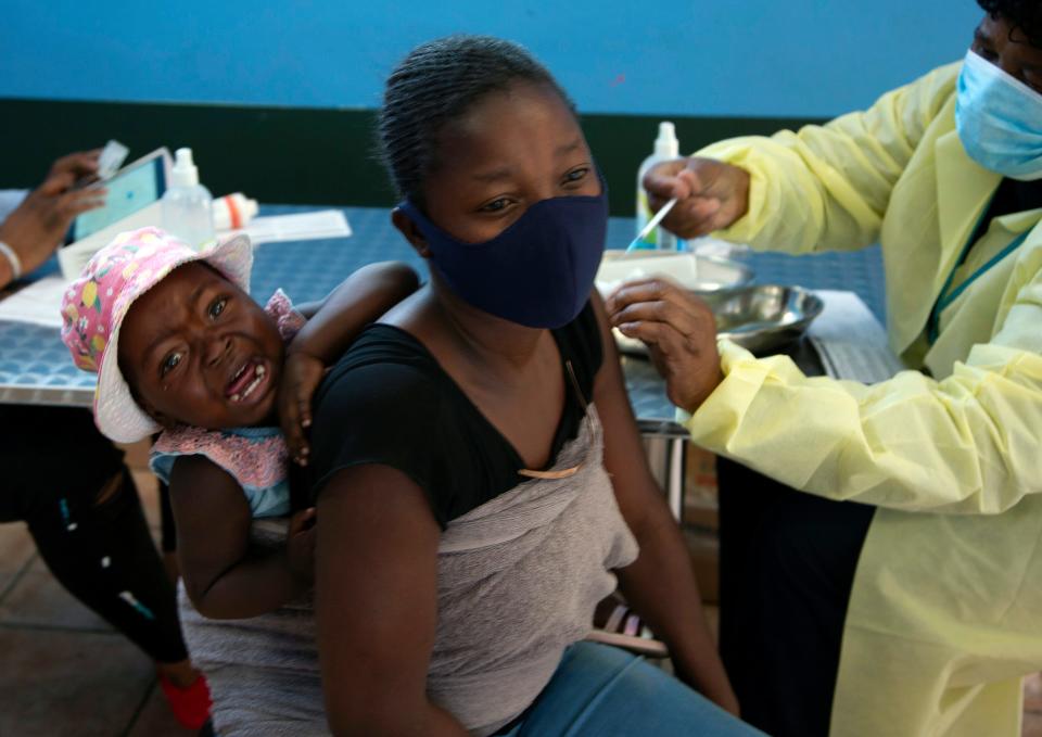 A baby cries as her mother receives her Pfizer vaccine against COVID-19, in Diepsloot Township near Johannesburg Thursday, Oct. 21, 2021. A new COVID-19 variant has been detected in South Africa that scientists say is a concern because of its high number of mutations and rapid spread among young people in Gauteng, the country's most populous province, Minister of Health Joe Phaahla announced Thursday, Nov. 25, 2021.