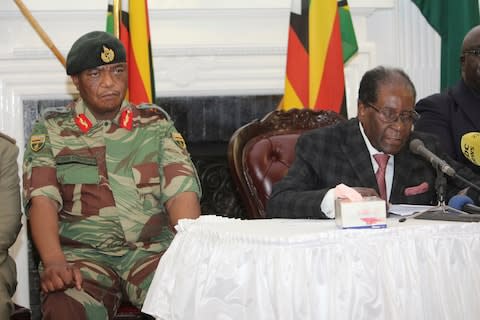 Gen Constantino Chiwenga, head of the Zimbabwean military, looks on while Robert Mugabe reads a speech on Sunday - Credit:  Tsvangirayi Mukwazhi/AP