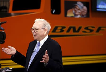 Berkshire Hathaway Chairman Warren Buffett talks in front of a mock BNSF railroad engine at the Berkshire Hathaway annual meeting in Omaha, Nebraska in this May 1, 2010 file photograph. REUTERS/Rick Wilking/Files