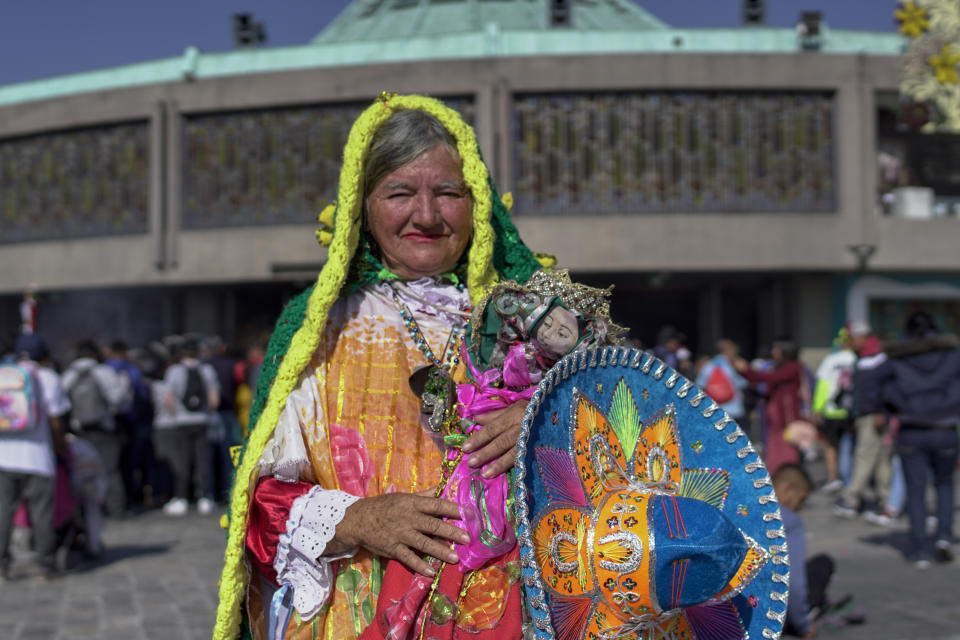 Ana Rita Ruelas, from Jalisco state, poses for a portrait dressed as the Virgin of Guadalupe, outside the Basilica of Guadalupe in Mexico City, early Monday, Dec.12, 2022. Devotees of the Virgin of Guadalupe make the pilgrimage for her Dec. 12 feast day, the anniversary of one of several apparitions of the Virgin Mary witnessed by an Indigenous Mexican man named Juan Diego in 1531. (AP Photo/Aurea Del Rosario)