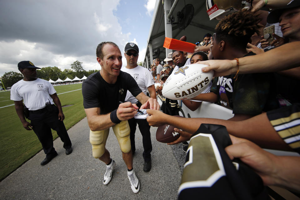 New Orleans Saints quarterback Drew Brees signs autographs for fans after training camp at their NFL football training facility in Metairie, La., Monday, July 29, 2019. (AP Photo/Gerald Herbert)