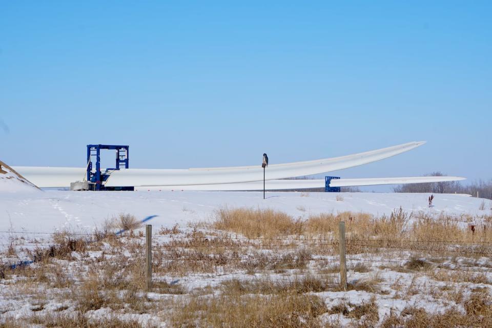 Turbine blades and sections of the metal tower are stored at a yard near Hanna, Alta, before they are installed.