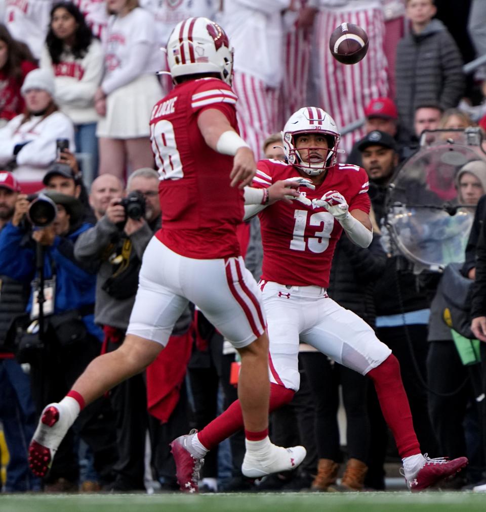 Wisconsin quarterback Tanner Mordecai (8) completes a pass to wide receiver Chimere Dike during the game against Iowa. Dike's 17.6 yards per catch lead UW.
