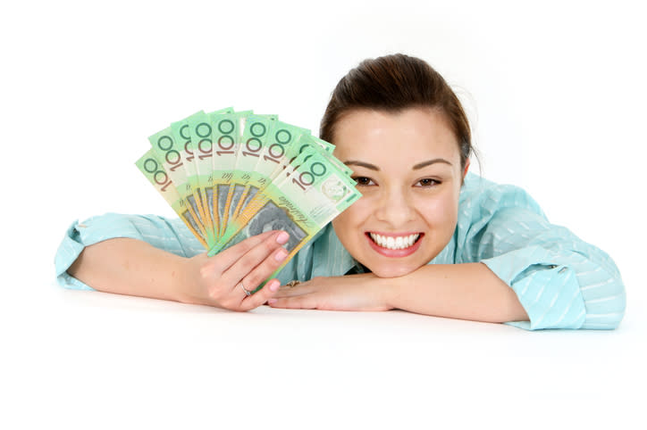 Attractive woman holding lots of Australian Money