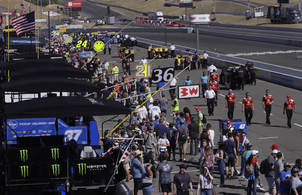 Cars are pushed into pit row in preparation for a NASCAR Sprint Cup Series auto race Sunday, June 23, 2019, in Sonoma, Calif. (AP Photo/Ben Margot)