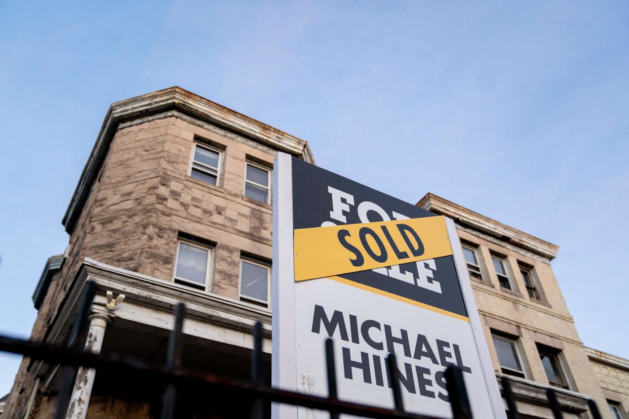 A sold banner is displayed over a For Sale sign in front of a house in Washington, DC, on March 14, 2022. (Photo by Stefani Reynolds / AFP) (Photo by STEFANI REYNOLDS/AFP via Getty Images)