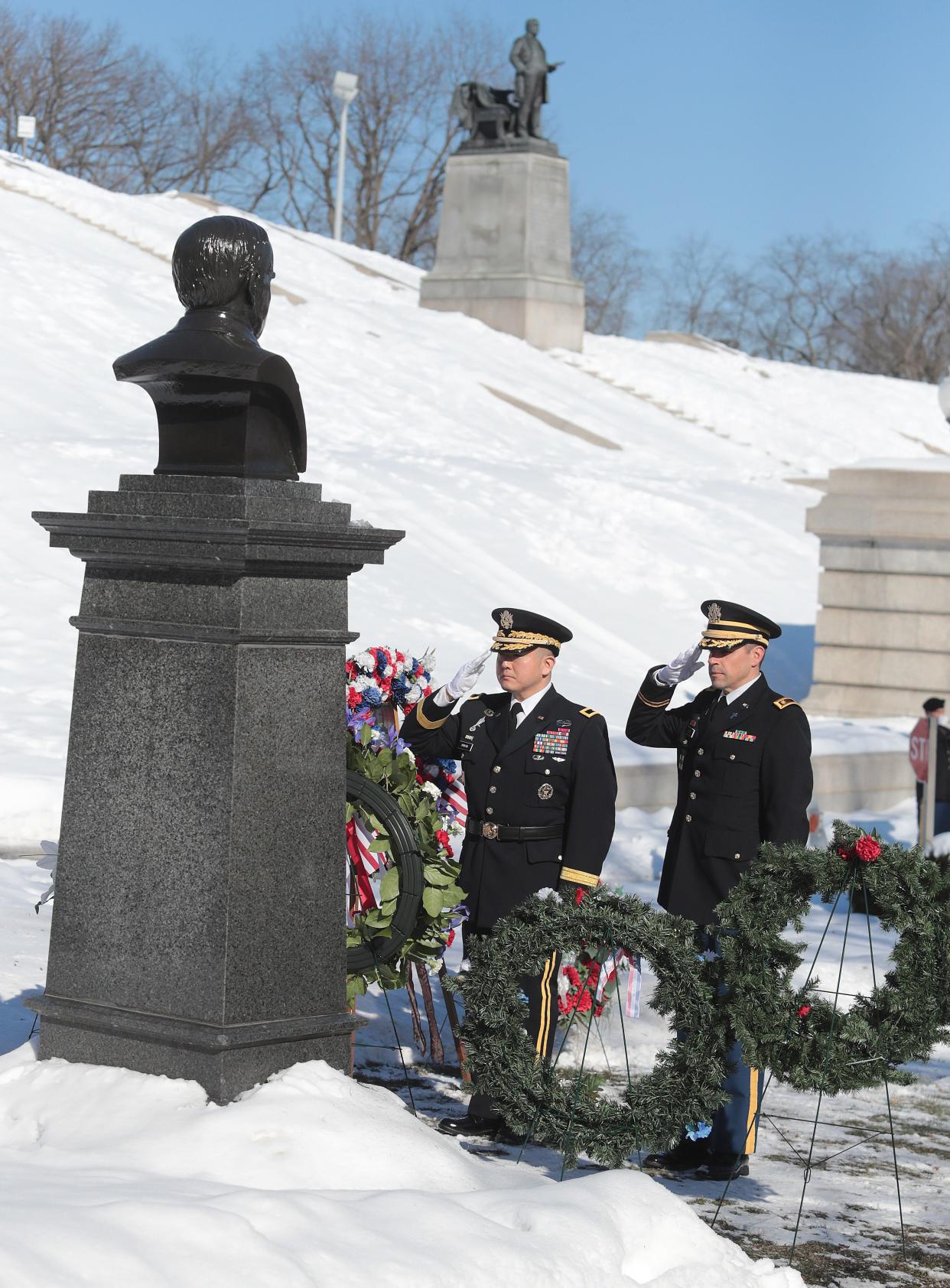 Brig. Gen. Jake S. Kwon, left, on behalf of President Joe Biden, and Maj. Timothy Paroz, salute the bust of President William McKinley at the annual wreath-laying ceremony Saturday honoring McKinley's birthday.