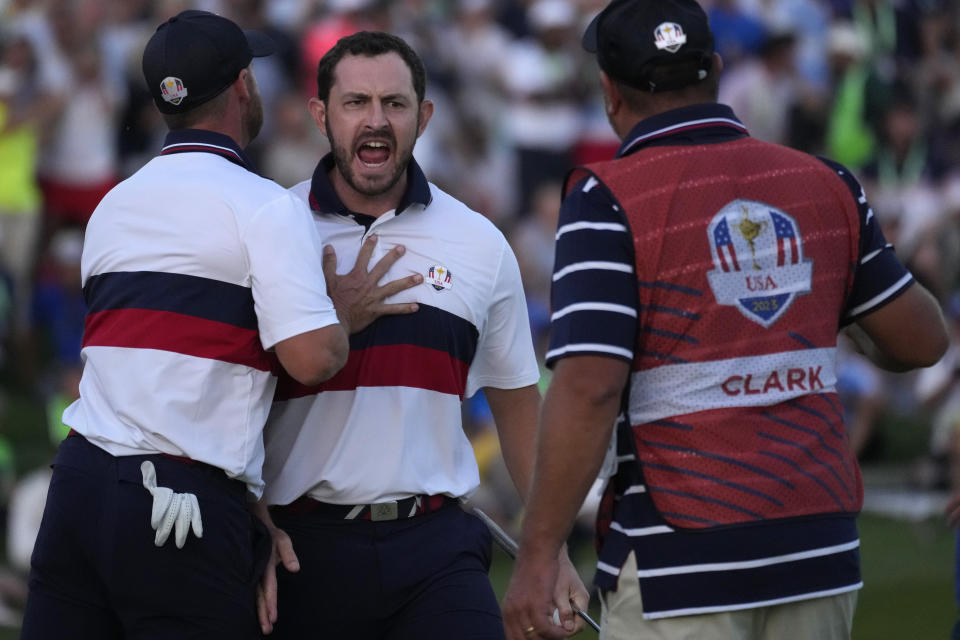 United States' Patrick Cantlay, centre celebrates with playing partner United States' Wyndham Clark, left, after winning his afternoon Fourballs match on the 18th green at the Ryder Cup golf tournament at the Marco Simone Golf Club in Guidonia Montecelio, Italy, Saturday, Sept. 30, 2023. (AP Photo/Andrew Medichini)