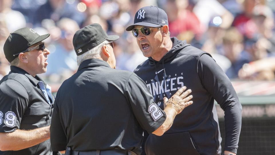 Apr 12, 2023; Cleveland, Ohio, USA; New York Yankees manager Aaron Boone argues a call with umpire Chris Guccione, left, and umpire Larry Vanover, middle, during the first inning against the Cleveland Guardians at Progressive Field. Boone was ejected.