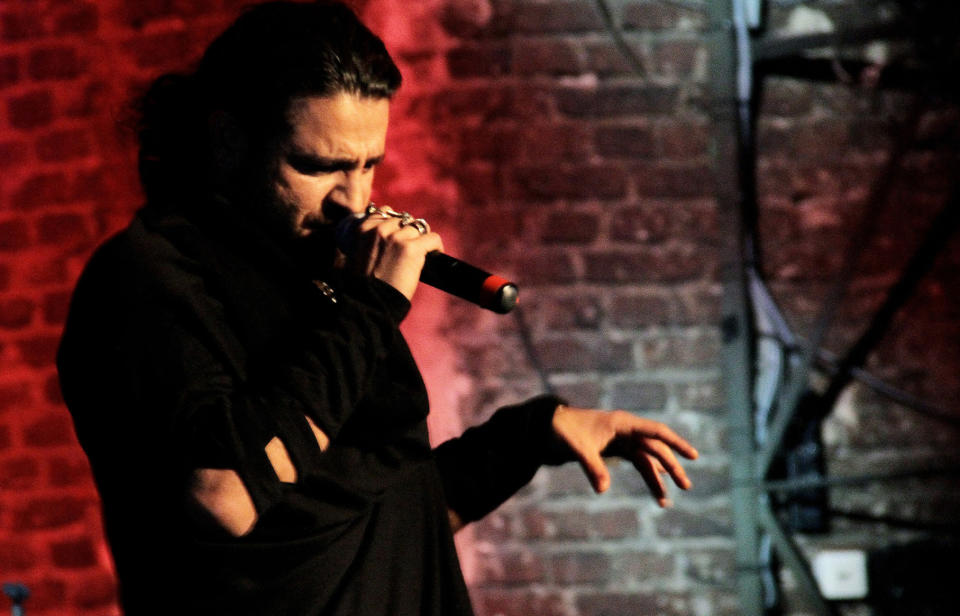 In this undated picture publicly provided by the Shahin Najafi managment, rapper Shahin Najafi performs in Duesseldorf , Germany. The Iranian-born singer who went into hiding after receiving death threats for allegedly insulting a Shiite saint said Friday he didn't intend to provoke the wrath of religious extremists. Shahin Najafi, who has lived in Germany since 2005, said he plans to continue writing and eventually performing songs despite the threats against him, which appeared on online forums and in his email inbox last week. "I'm in a safe place, reading and playing my guitar," he told The Associated Press in a telephone call. (AP Photo/ Schahryar Ahadi, Najafi Managment) EDITORIAL USE ONLY