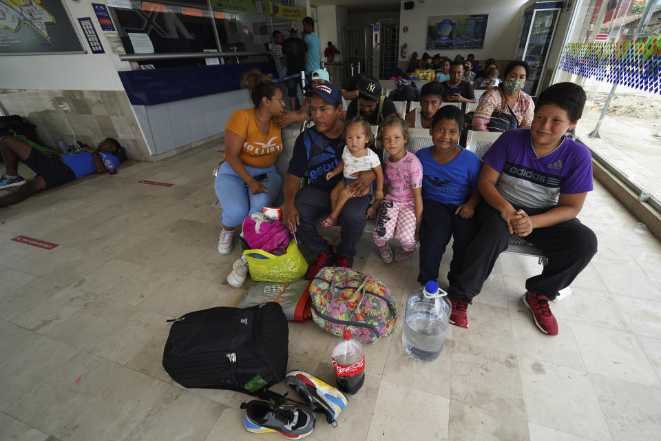 Nicaraguan migrant Jose Soliz Elias sits with his family at the bus terminal after receiving documents that allow them to legally travel through Mexico, in Huixtla, Chiapas state, Mexico, Friday, June 10, 2022. Thousands of migrants left Tapachula by foot at the start of the week, tired of waiting for normalize their status in a region with little work, with the ultimate goal of reaching the U.S. (AP Photo/Marco Ugarte)