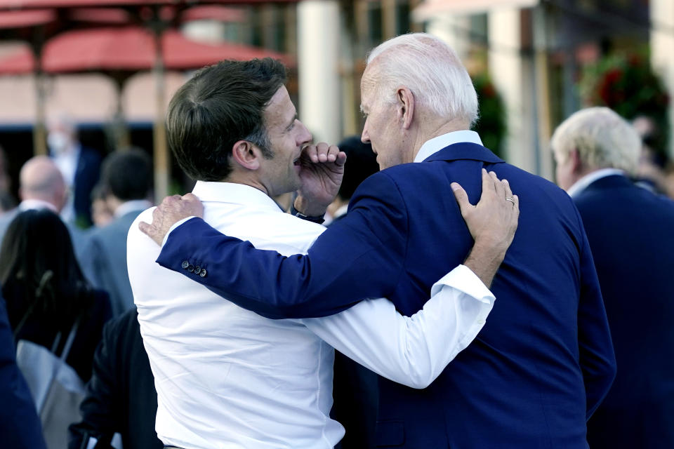 FILE - French President Emmanuel Macron whispers to U.S. President Joe Biden following their dinner at the G7 Summit in Elmau, Germany, June 26, 2022. Macron is heading to Washington for the first state visit of Biden’s presidency—a reviving of diplomatic pageantry that had been put on hold because of the COVID-19 pandemic. (AP Photo/Susan Walsh, File)