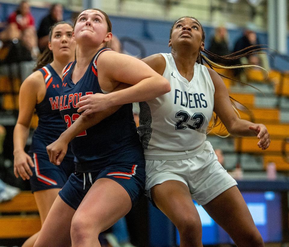 Framingham High School senior captain Nina Edwards, right, fights for a rebound against Walpole junior Isabelle Adams, Jan. 5, 2024.