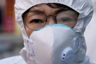 An employee from a disinfection service company prepares to sanitize a shopping district in Seoul