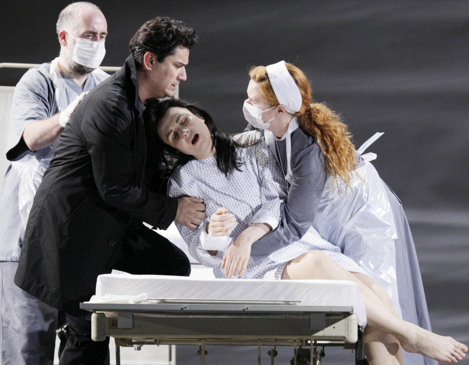 In this picture taken Wednesday, May 23, 2012, Nenad Marinkovic in the role of Giuseppe, Saimir Pirgu as Alfredo Germont, Irina Lungu as Violetta Valery, and Claire Egan as Nun, from left, perform during a dress rehearsal at the Theater an der Wien in Vienna, Austria, for the opera "La Traviata" by Giuseppe Verdi. (AP Photo/dapd, Lilli Strauss)