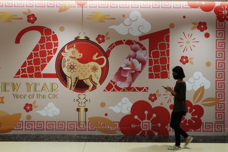 A shopper passes by Chinese New Year decorations at a shopping mall in Singapore's Marina Bay area. (PHOTO: Getty Images)