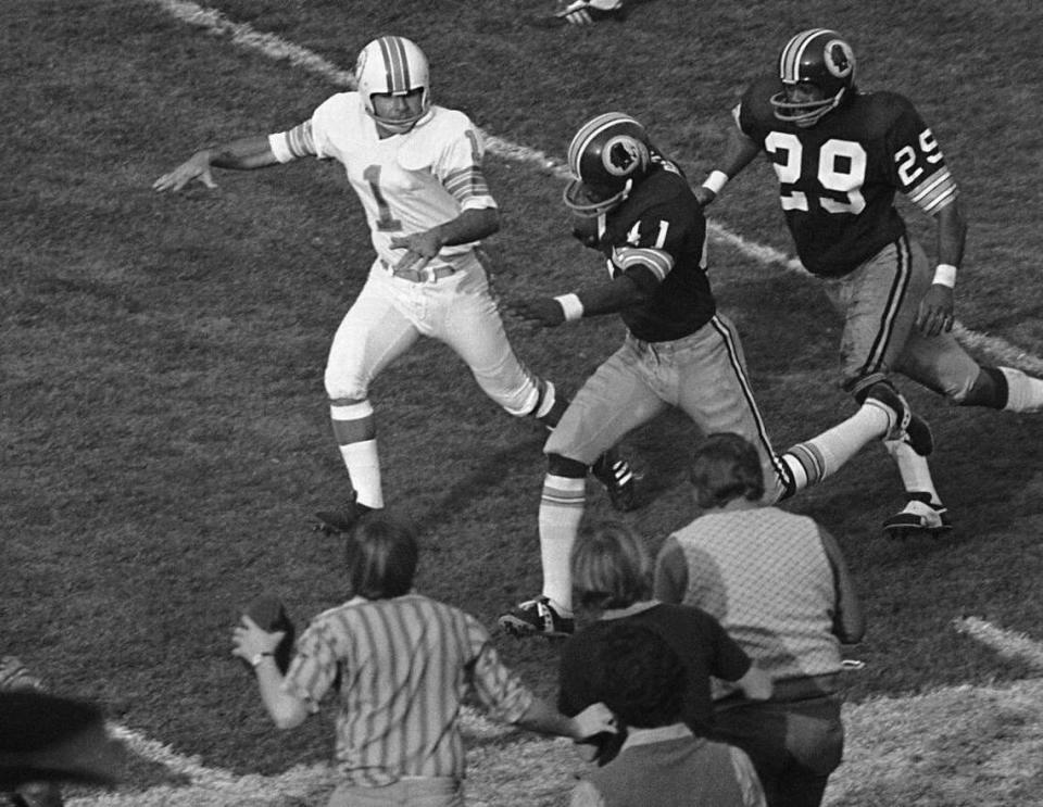 The tackle portion of Garo’s Gaffe. After a field goal attempt by Dolphins kicker Garo Yepremian was blocked, Yepremian picked up the ball and tried to pass. The ball fluttered up into the air and Yepremian batted it with his recapture attempt. Washington’s Mike Bass (41) grabbed it, raced past Yepremian’s flailing tackle attempt and scored Washington’s only touchdown of Super Bowl VII.