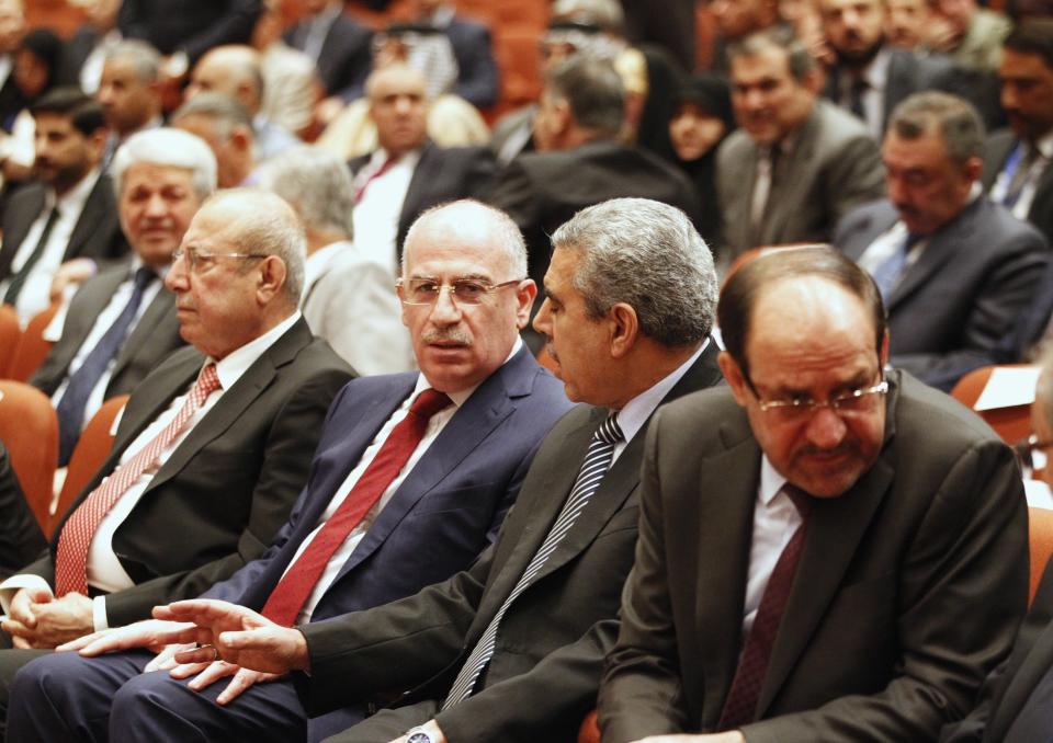 Iraqi Prime Minister Nuri al-Maliki (R) and Osama al-Nujaifi, speaker of the Iraqi Council of Representatives (3nd R), attend a session at the Parliament headquarters in Baghdad July 1, 2014. T Sunnis and Kurds abandoned the first meeting of Iraq's new parliament on Tuesday after Shi'ites failed to name a prime minister to replace Nuri al-Maliki, wrecking hopes that a unity government would be swiftly built to save Iraq from collapse. REUTERS/Thaier Al-Sudani (IRAQ - Tags: POLITICS)